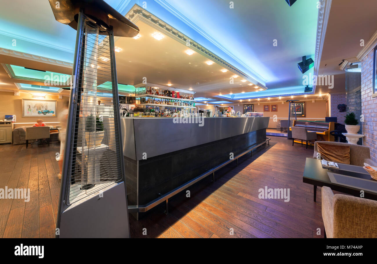 MOSCOW - JULY 2014: Interior of stylish Mediterranean cuisine Italian restaurant - 'SILLYCAT'. Restaurant room with a bar lined with metal in the midd Stock Photo