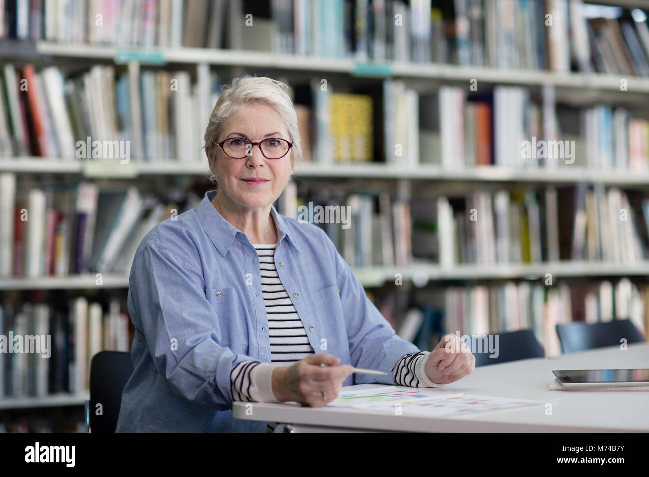 Portrait of mature student in college library Stock Photo