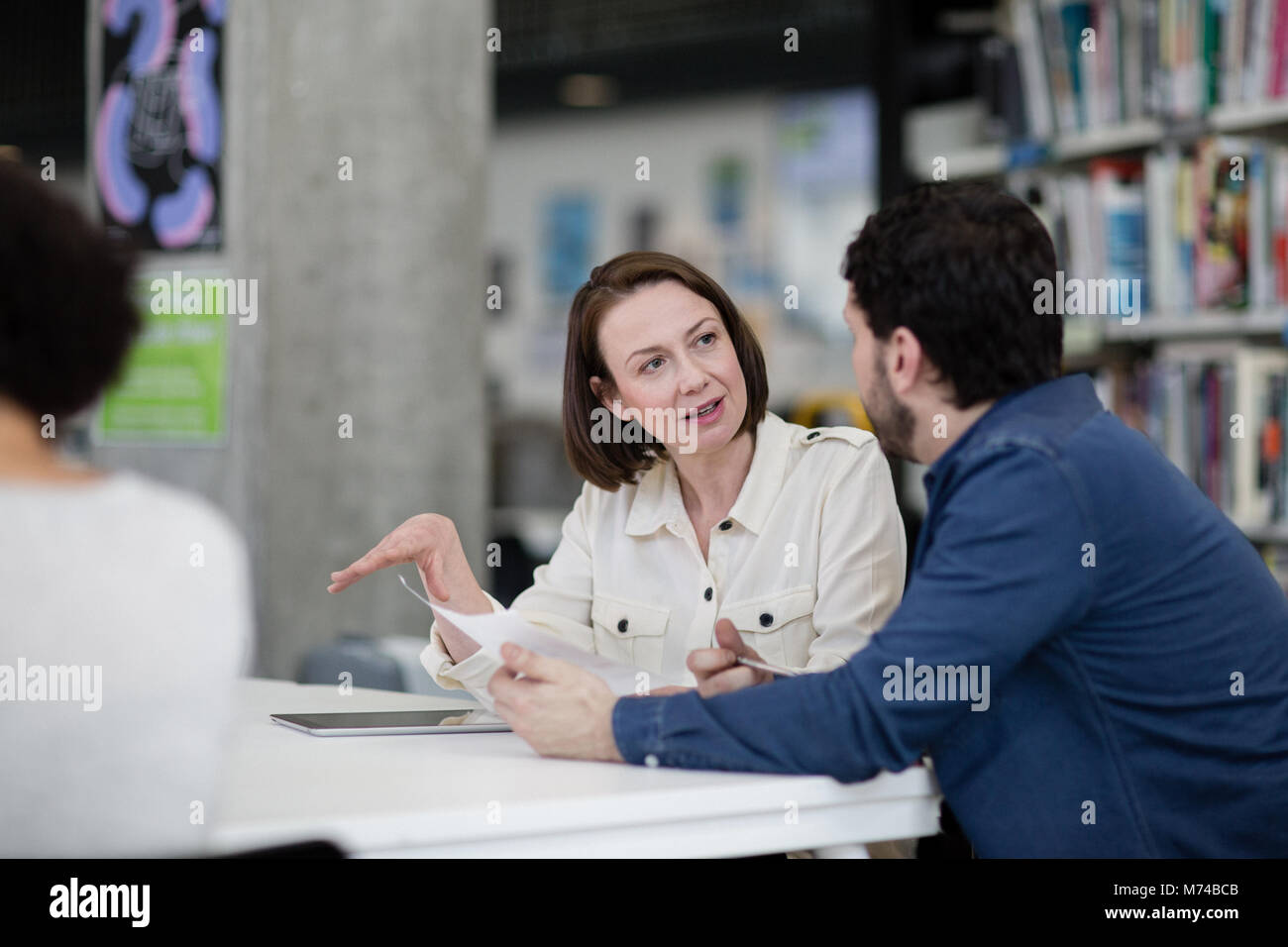 Mature students in library studying together Stock Photo