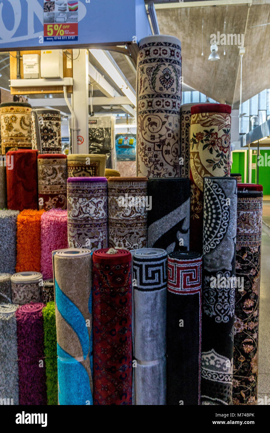 Rugs for sale at a market stall in the Queensgate Market, Huddersfield, West Yorkshire, England