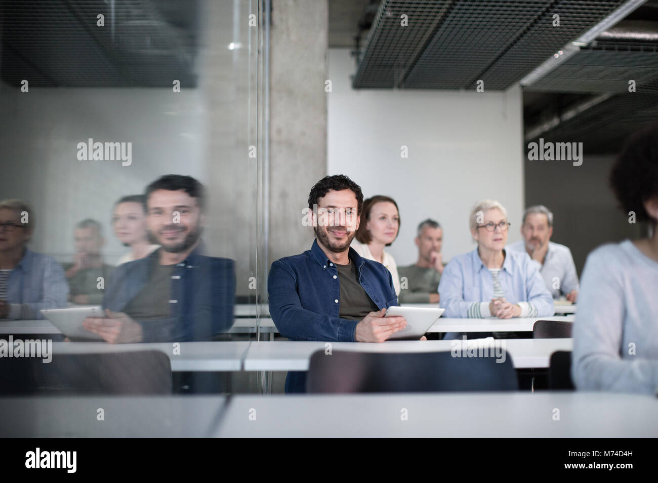 Portrait of mature student with digital tablet in a lecture Stock Photo