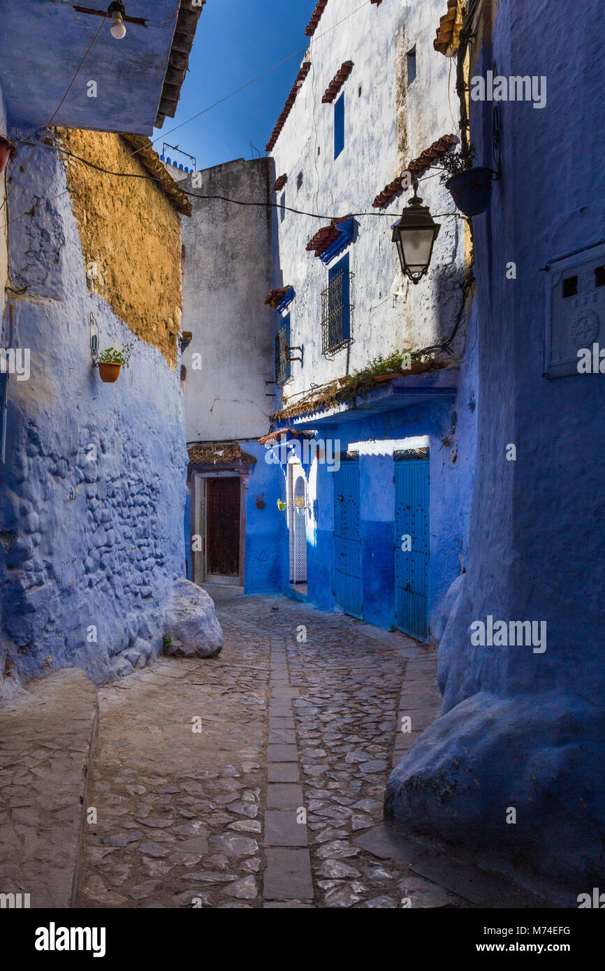 A colourful narrow street scene in the blue city of Chefchaouen, Morocco Stock Photo