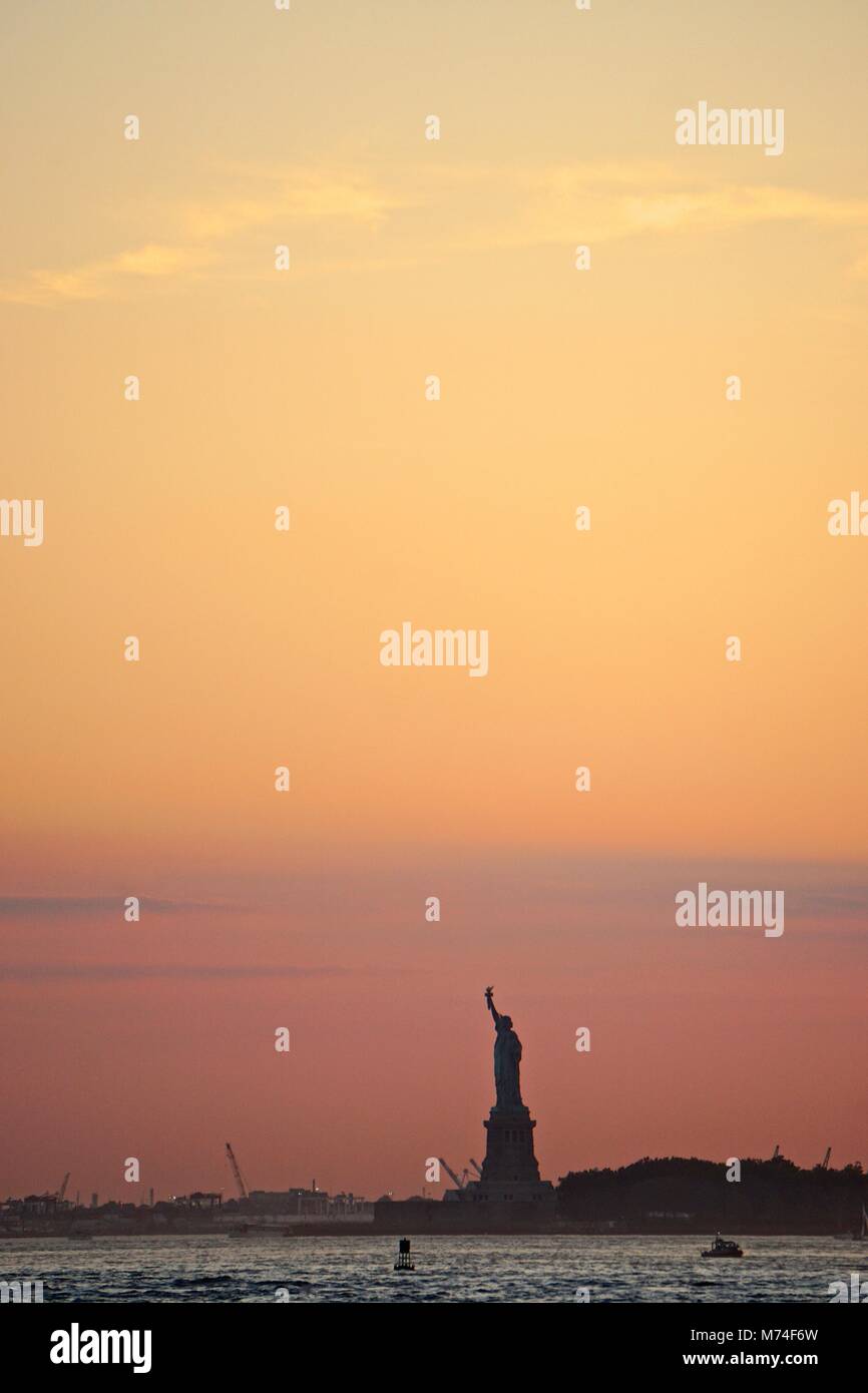 New York, NY, USA: The silhouette of the Statue of Liberty in a busy ...