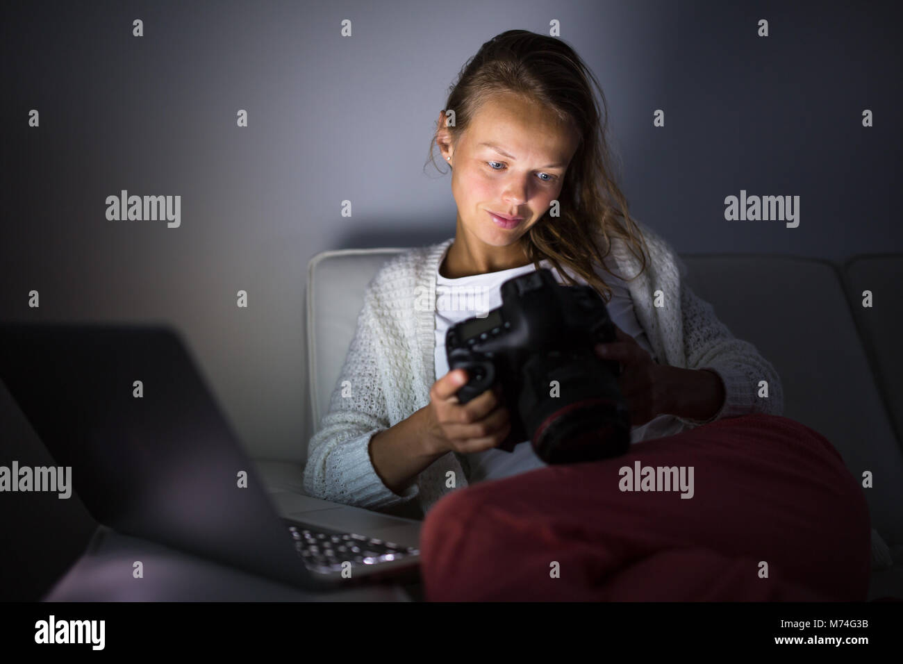 Very tired young woman, burning the midnigh oil working late at night on her laptop computer