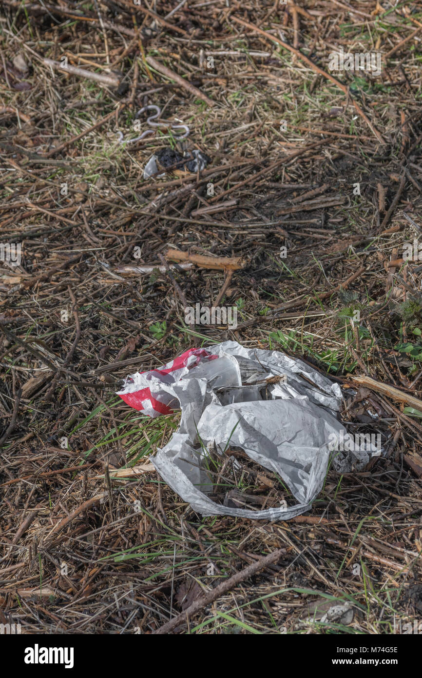 Everyday plastic items thrown into the environment as waste. Metaphor war on plastic, plastic rubbish. Stock Photo