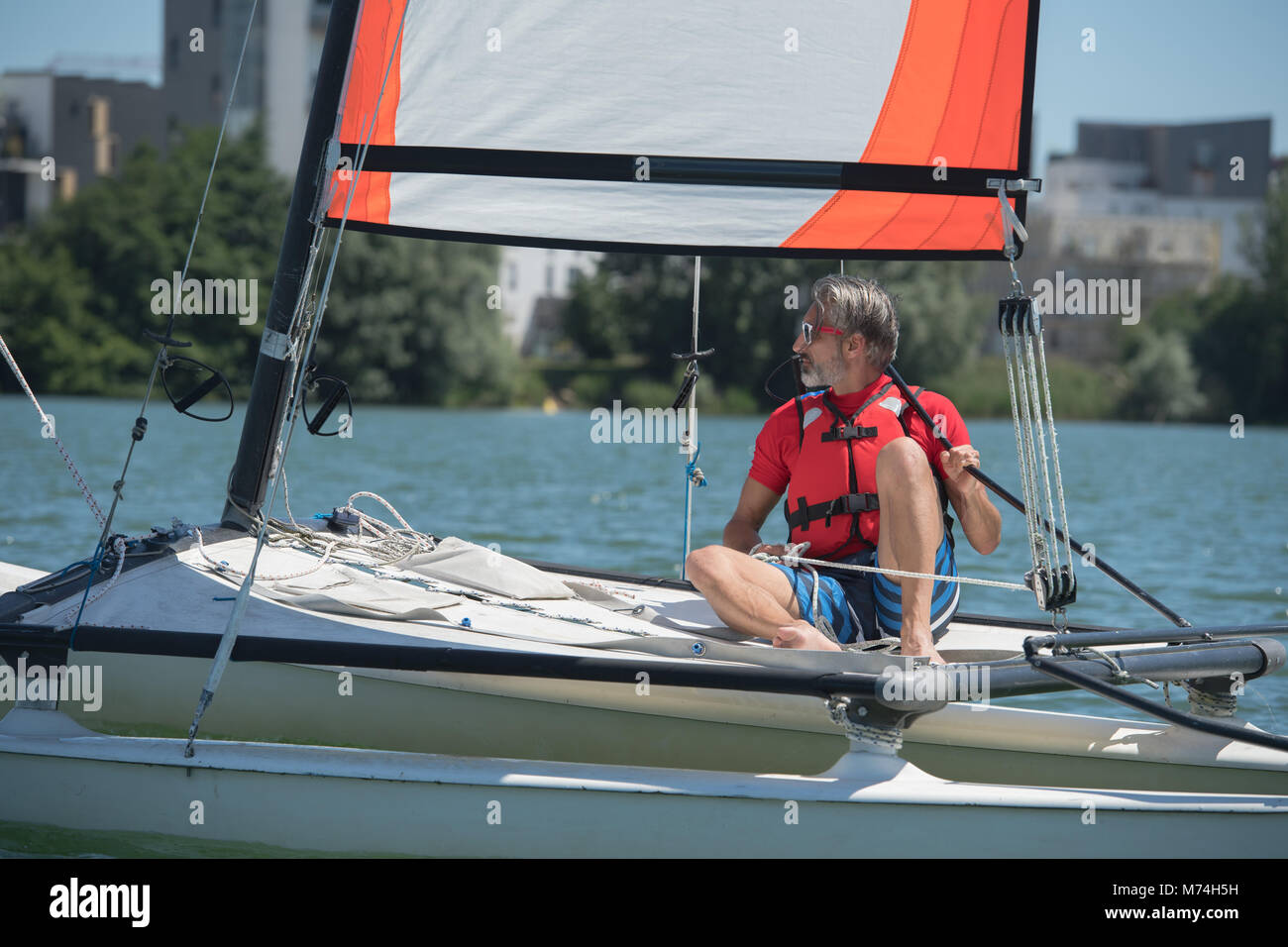 mature handsome man sailing on a lake Stock Photo - Alamy