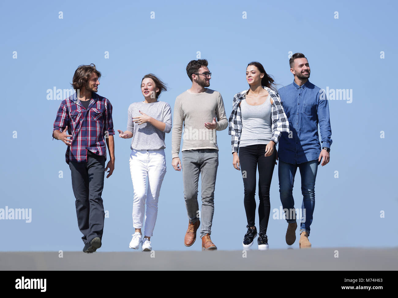 team of young people walking along the road.outdoors Stock Photo - Alamy