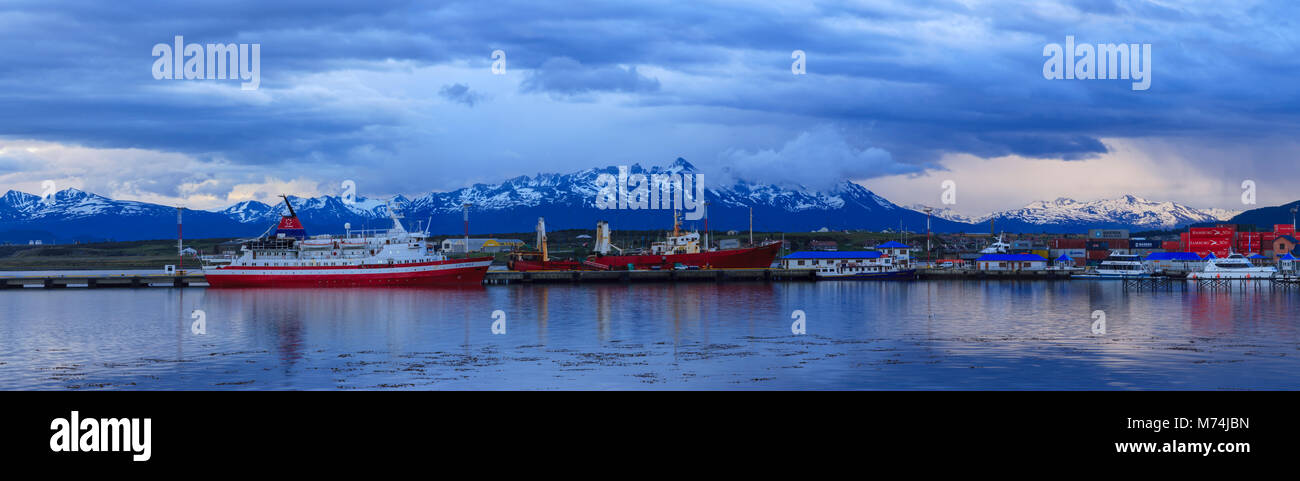 Sunrise Panorama Ushuaia harbor Patagonia, southernmost city in world tourism gateway to Antarctica, Andes mountain background, docked tourist ships Stock Photo