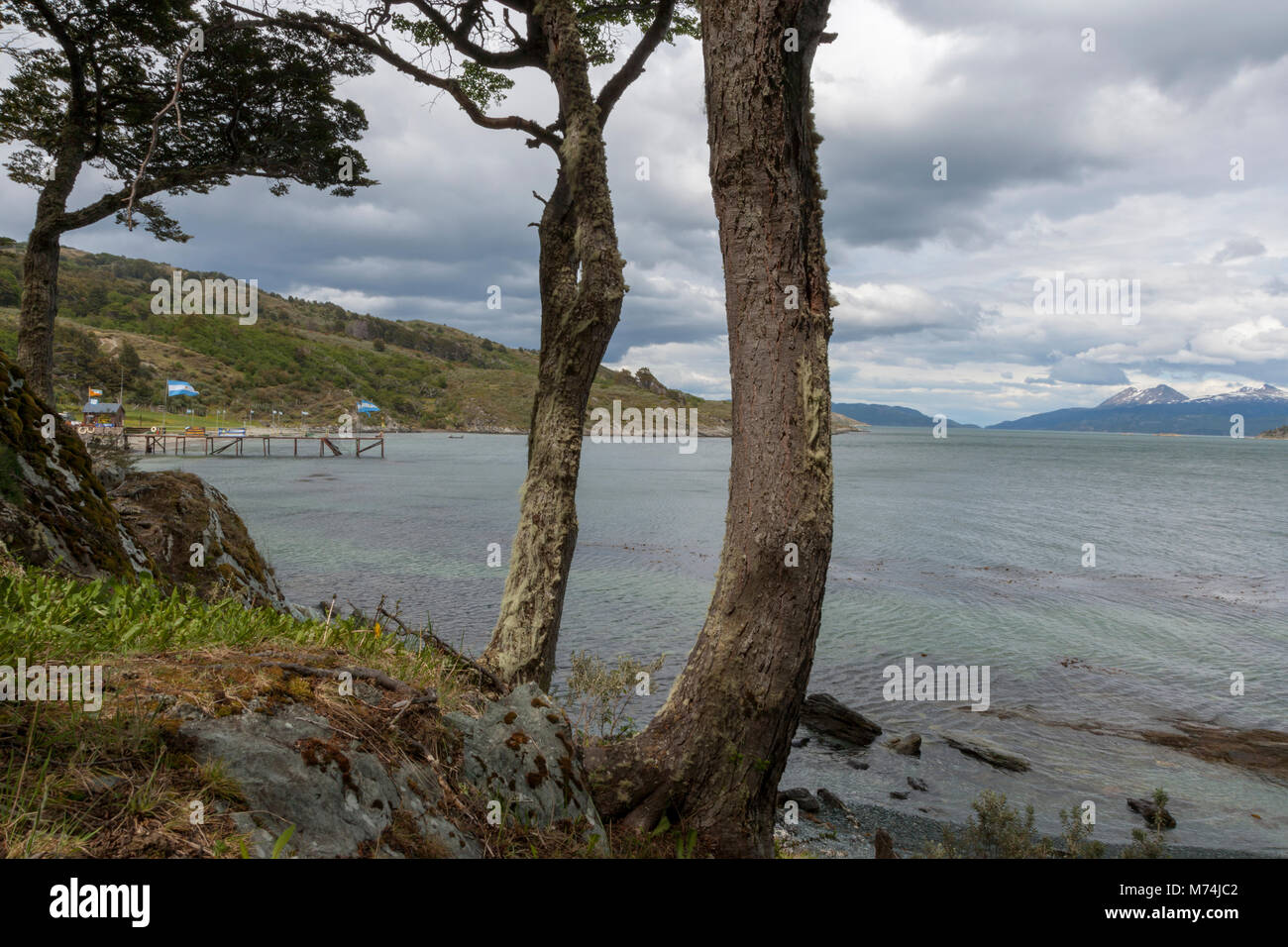 Tierra Del Fuego National Park, Ushuaia Argentina, subantarctic Patagonian forest is popular for tourism, Andes Mountains, boat dock cloudy sky, flag Stock Photo