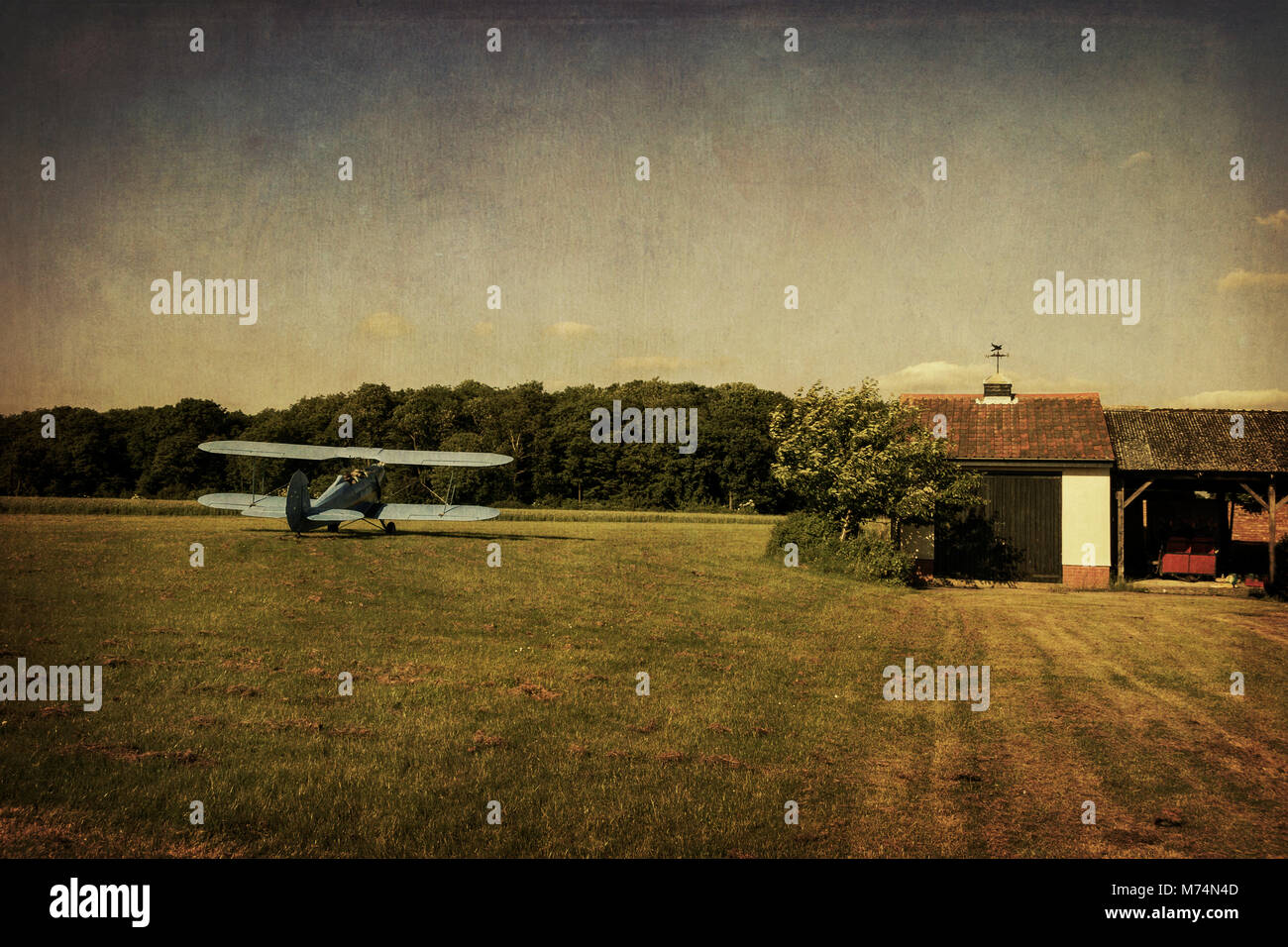 Biplane on a grass airstrip Stock Photo
