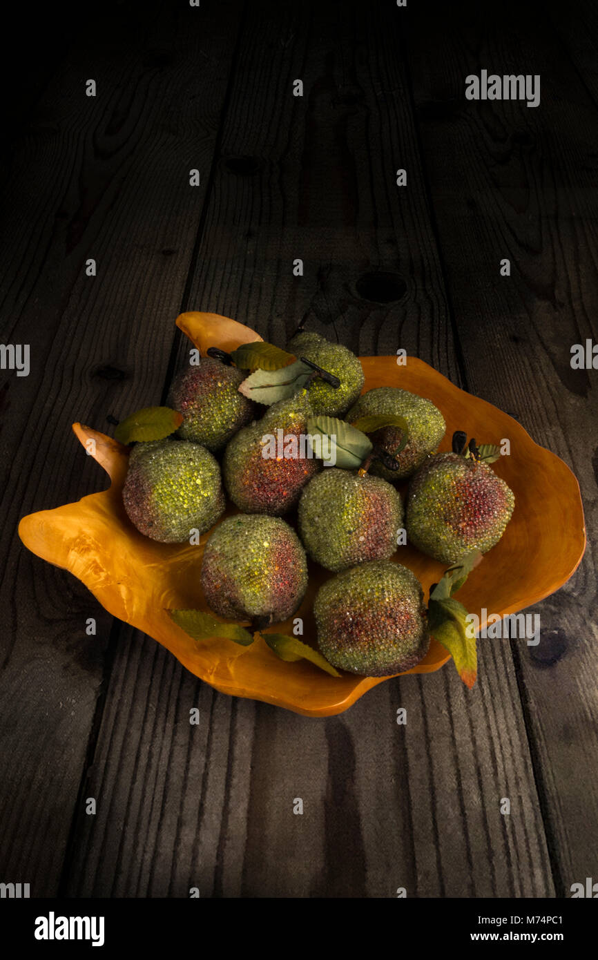Ornamental apples and pears in a wooden bowl Stock Photo