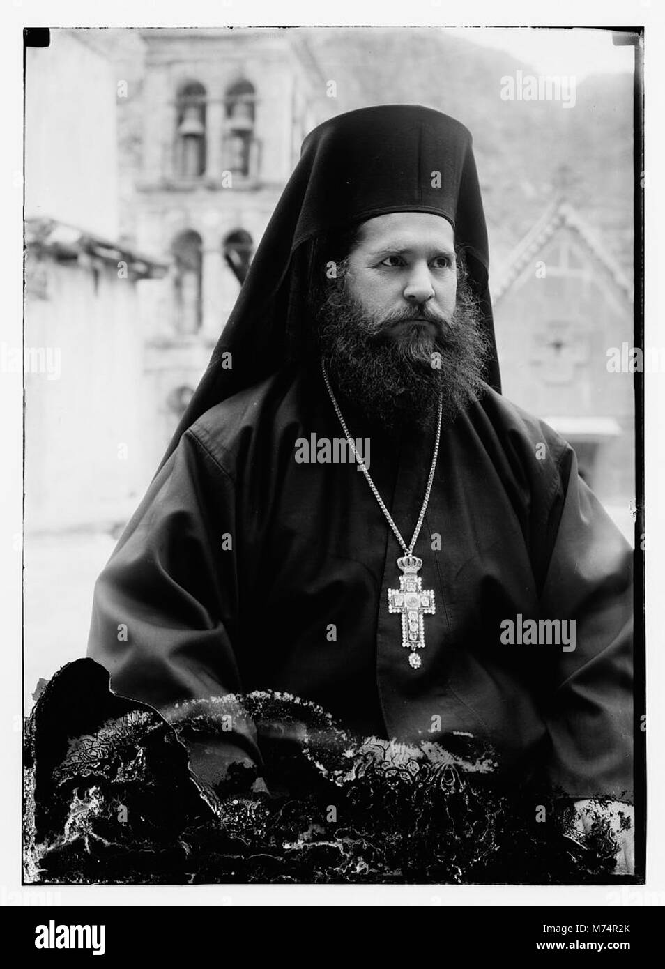 Greek Orthodox priest at St. Catherine's Monastery in the Sinai holding prized manuscript with silver cover from the library LOC matpc.09659 Stock Photo