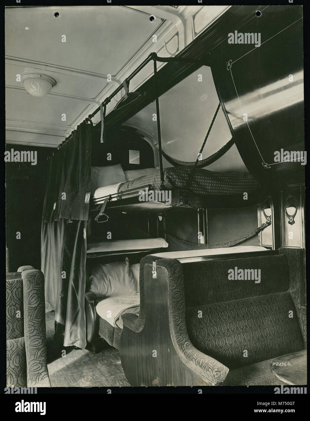 This image shows the interior of a train car with berths made down for ...