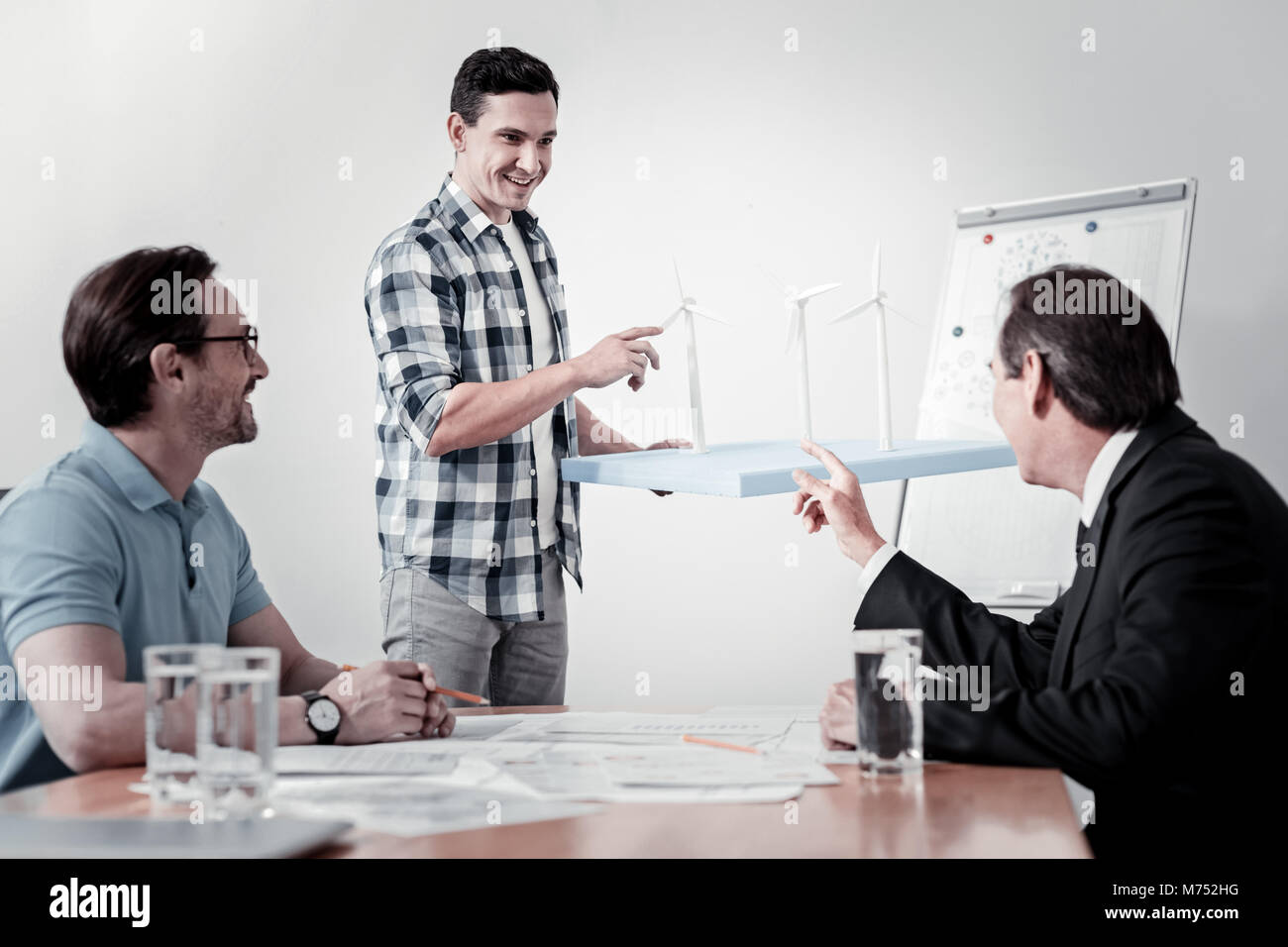 Positive delighted man demonstrating his models Stock Photo - Alamy
