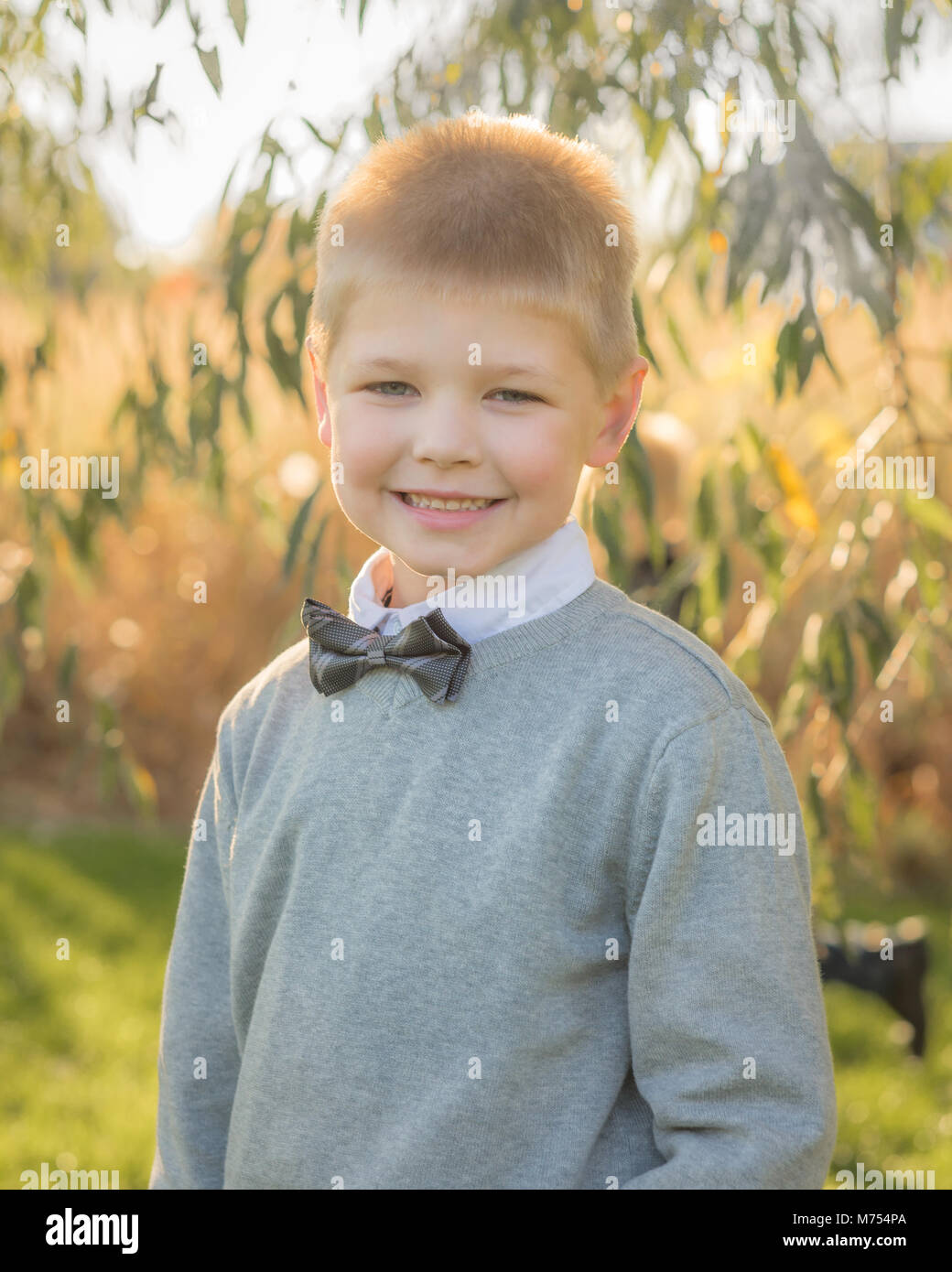 Seven year old boy playing outdoors in the Autumn Stock Photo