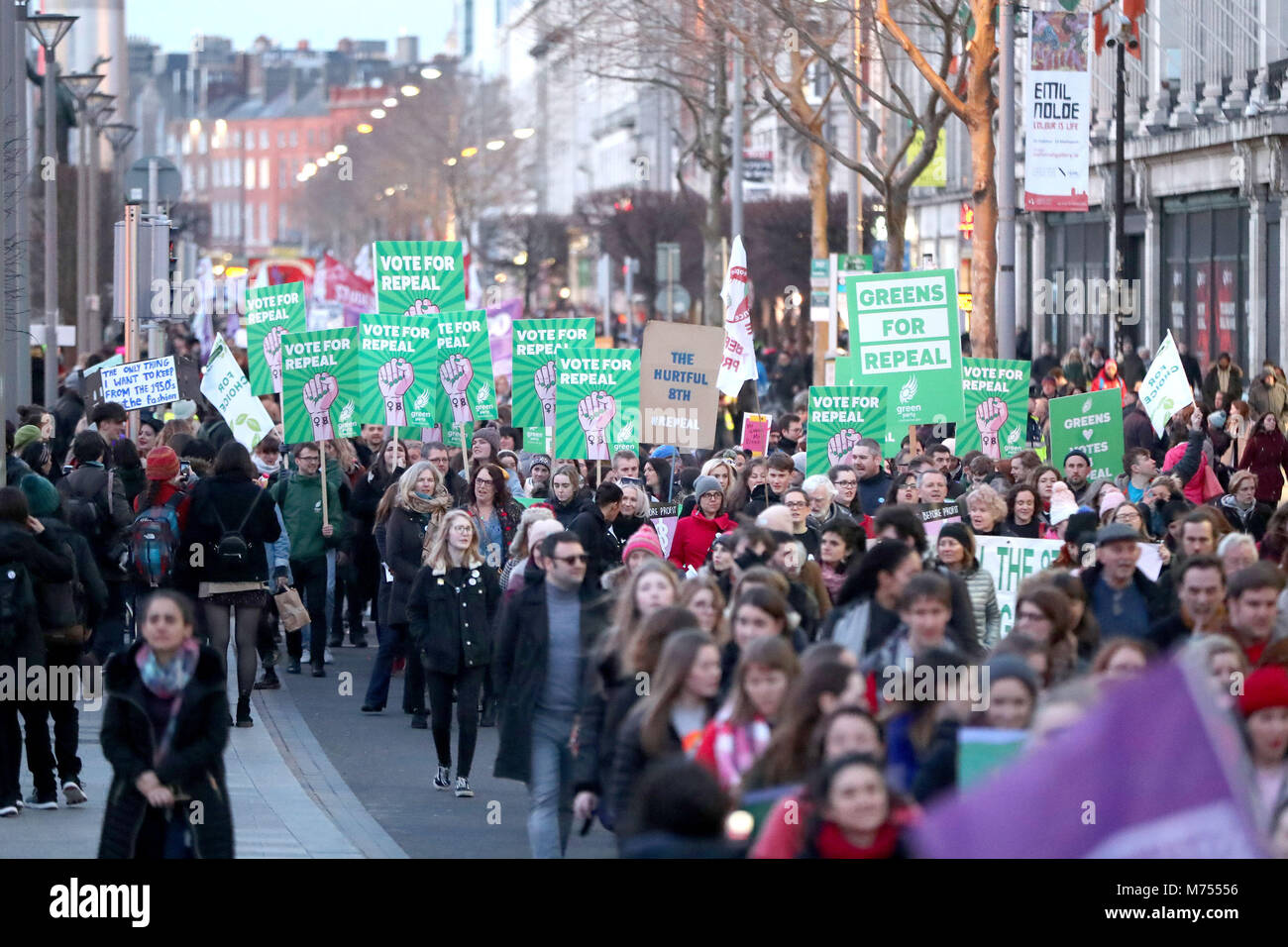 People carrying various signs, as participants take part in a march through Dublin city centre calling for the repeal of the 8th amendment to the Irish constitution. Stock Photo