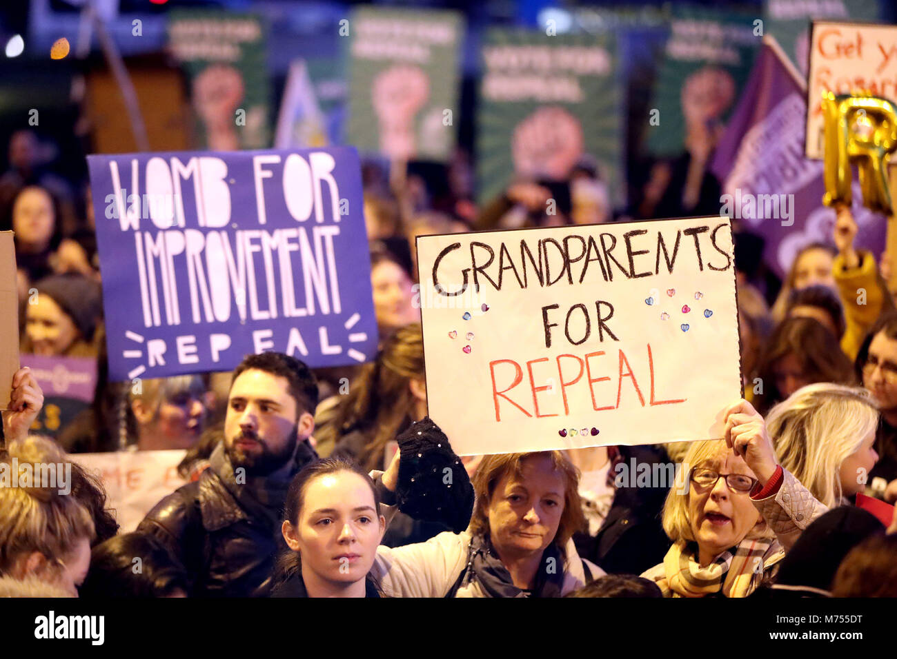 People carrying various signs, as participants take part in a march through Dublin city centre calling for the repeal of the 8th amendment to the Irish constitution. Stock Photo