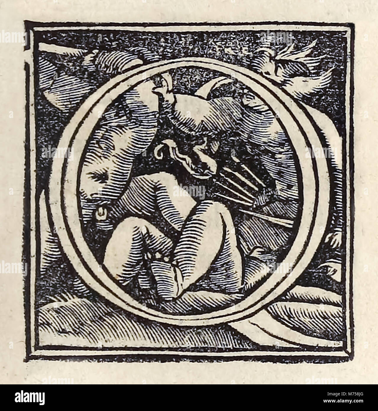 Illuminated 'O' from the 1518 Basel third edition of ‘Utopia’ by Sir Thomas More (1478–1535) first published in 1516. Woodcut by Hans Holbein the Younger (c.1497-1543) showing putti fighting. See more information below. Stock Photo