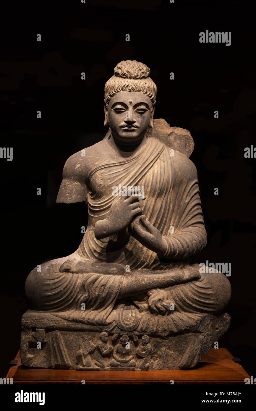 ancient seated Buddha schist statue image in the 2nd-3rd century, Kushan dynasty from Pakistan. Stock Photo