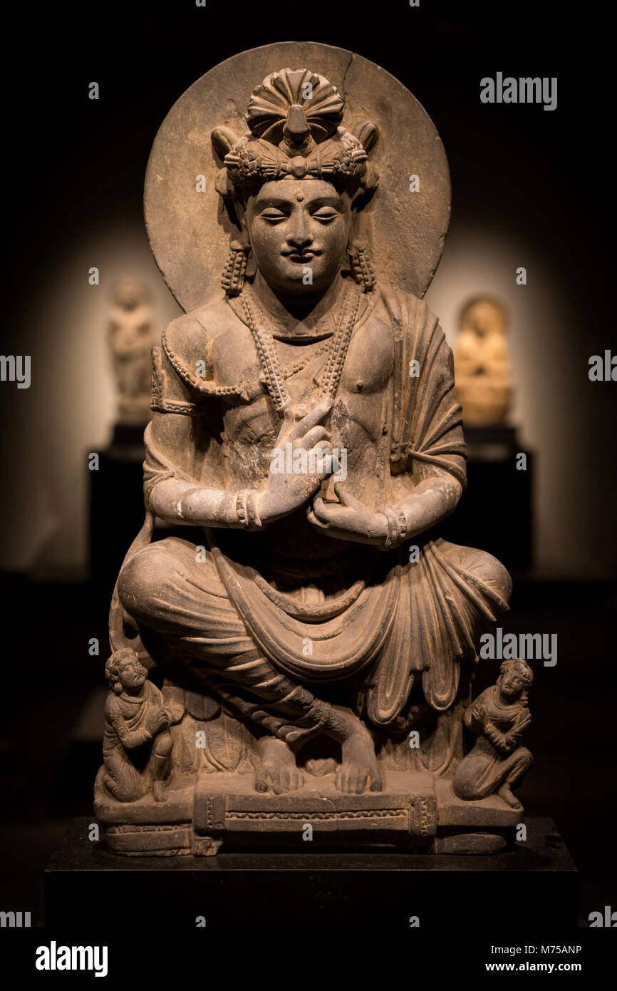 ancient cross-legged Bodhisattva schist statue image in 2nd century, Kushan dynasty from Gandhara, Pakistan. Stock Photo