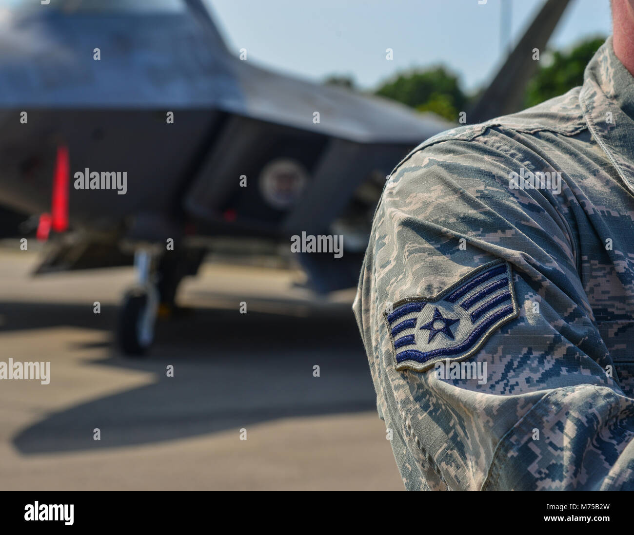 US Air Force Sign on the uniform of a soldier, with aircraft background ...