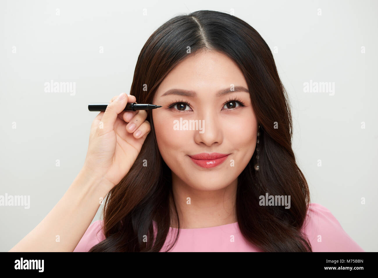 Beautiful young asian woman make-up with black eyeliner. Stock Photo