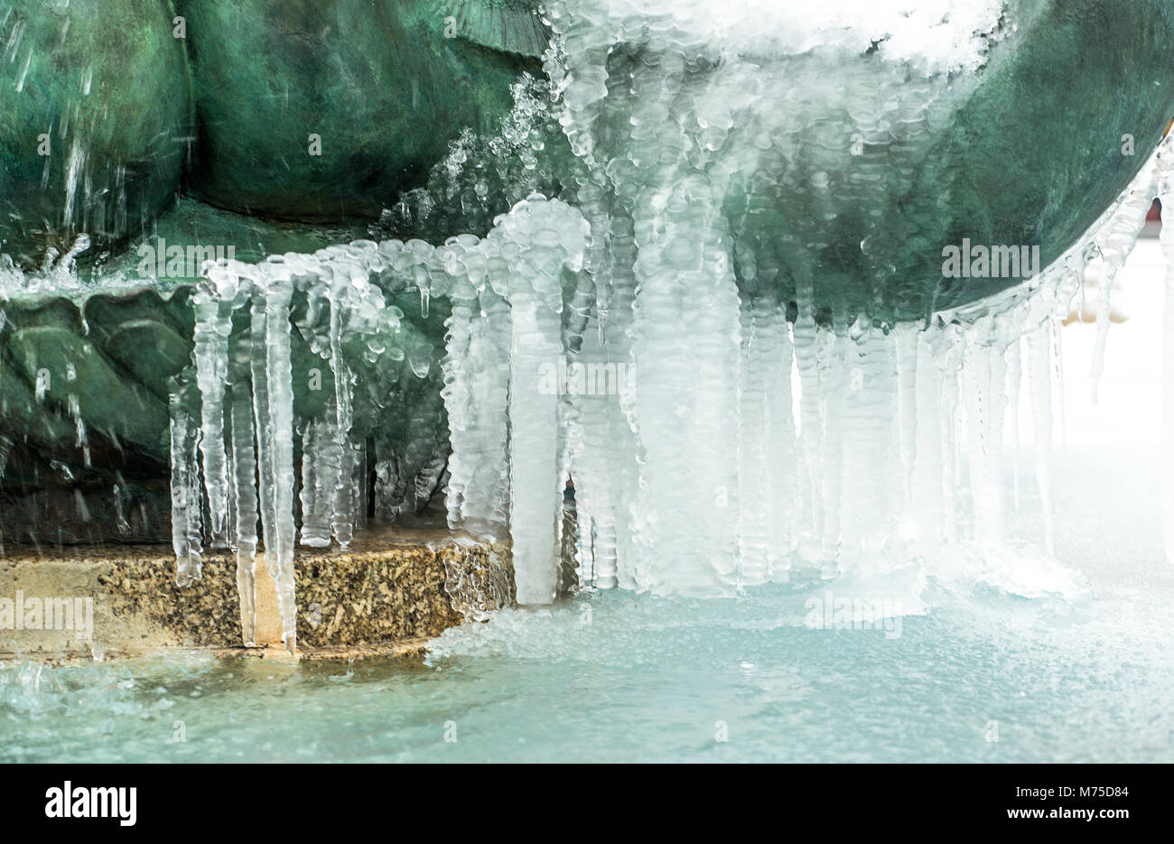 The fountains and water sculptures at Trafalgar Square, London, stand frozen and covered in ice, after recent severe winter weather hit the capital. Stock Photo