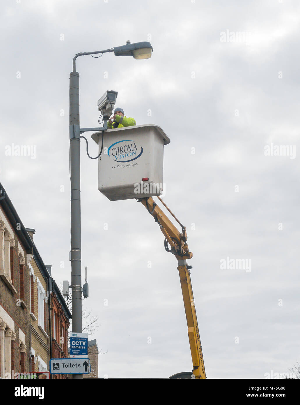 A CCTV camera being installed by a maintenance crew in Earlsfield, London Stock Photo