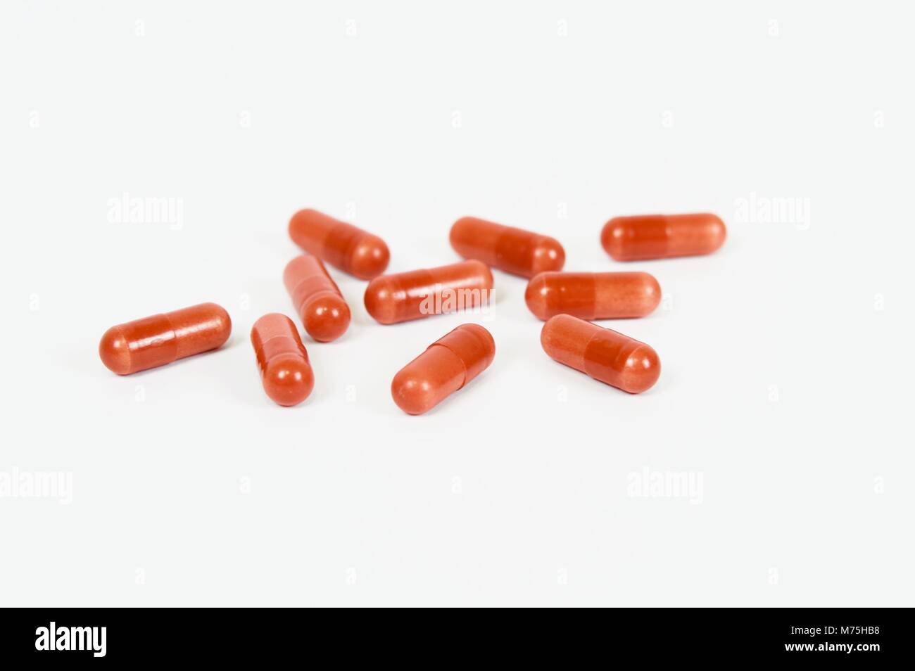 Garnet capsules on white background Stock Photo - Alamy