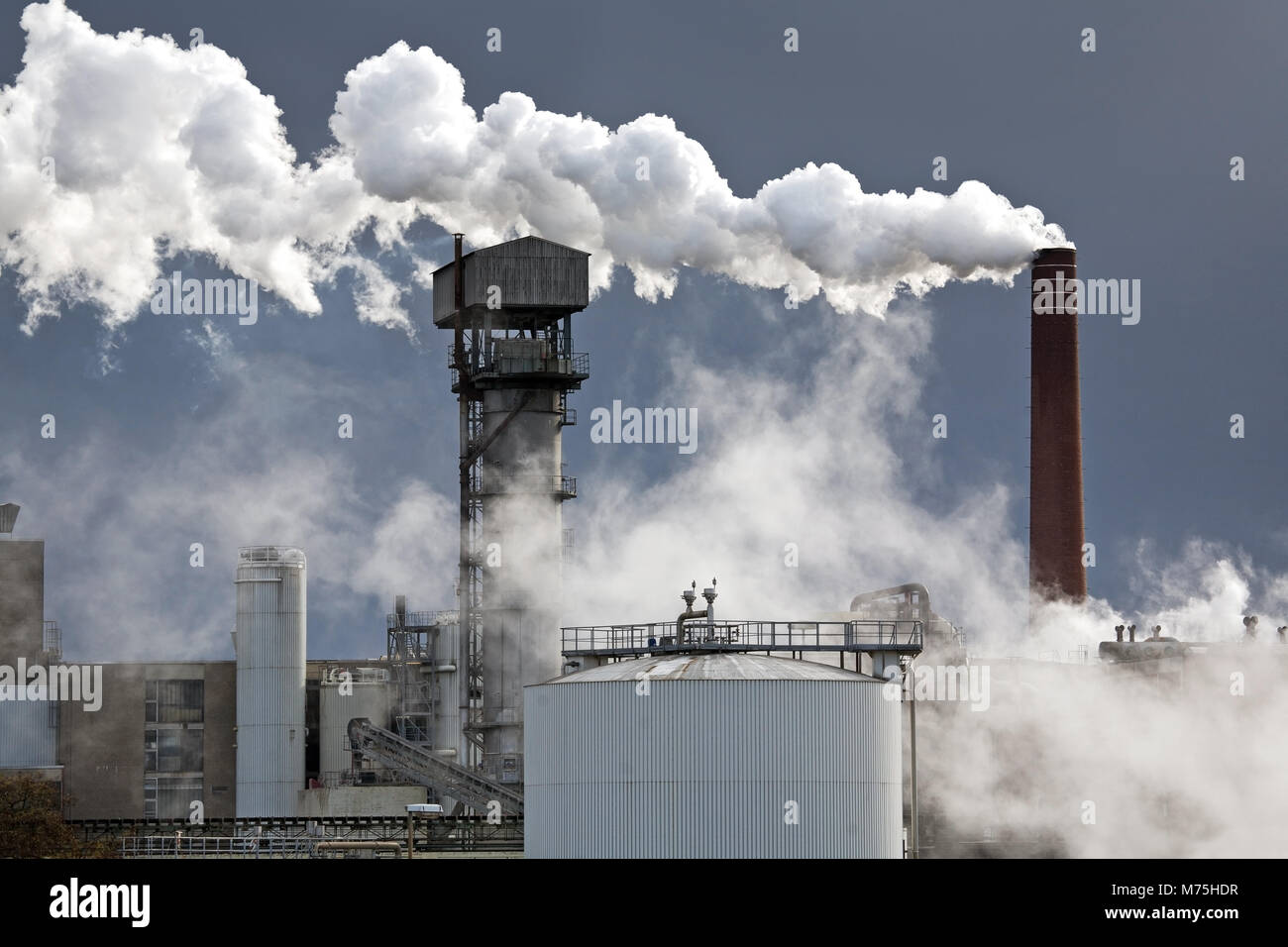 Sugar Factory in GrossGerau, Germany, with smoking chimney Stock Photo
