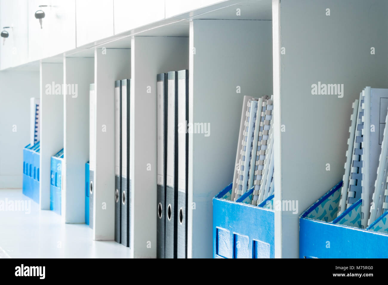 White office document cabinet, shelf and blue document boxes Stock Photo