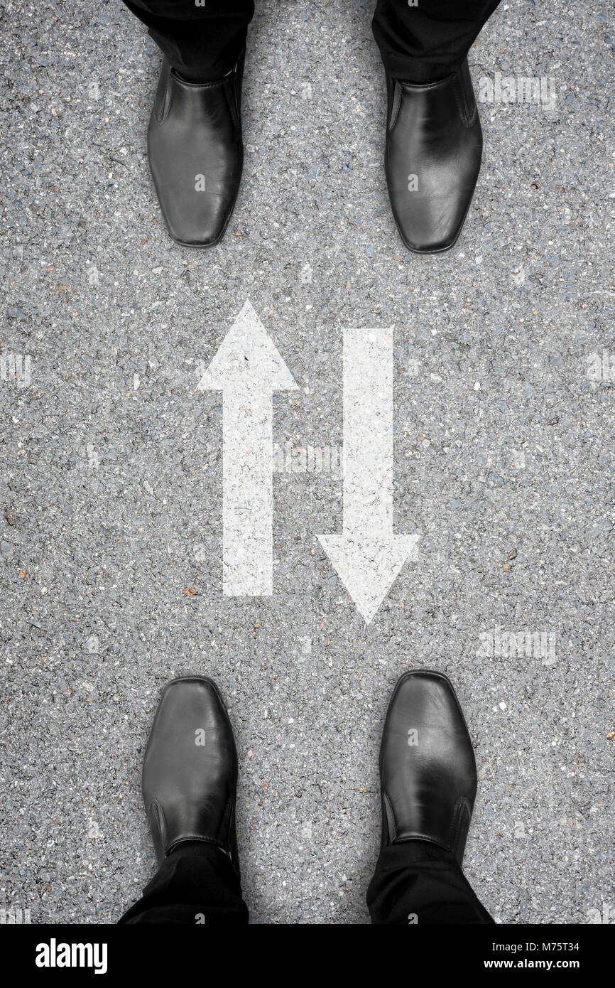 Two men standing in front of each other and two way drive sign between them. Represent two way communication in business to make success. Stock Photo