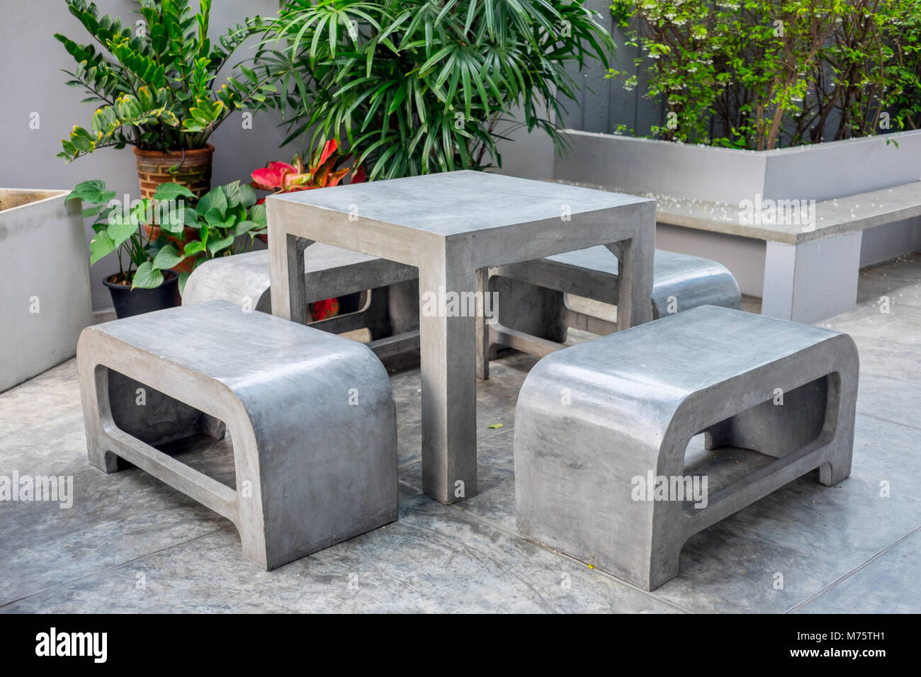 concrete outdoor furniture set in the small garden including on