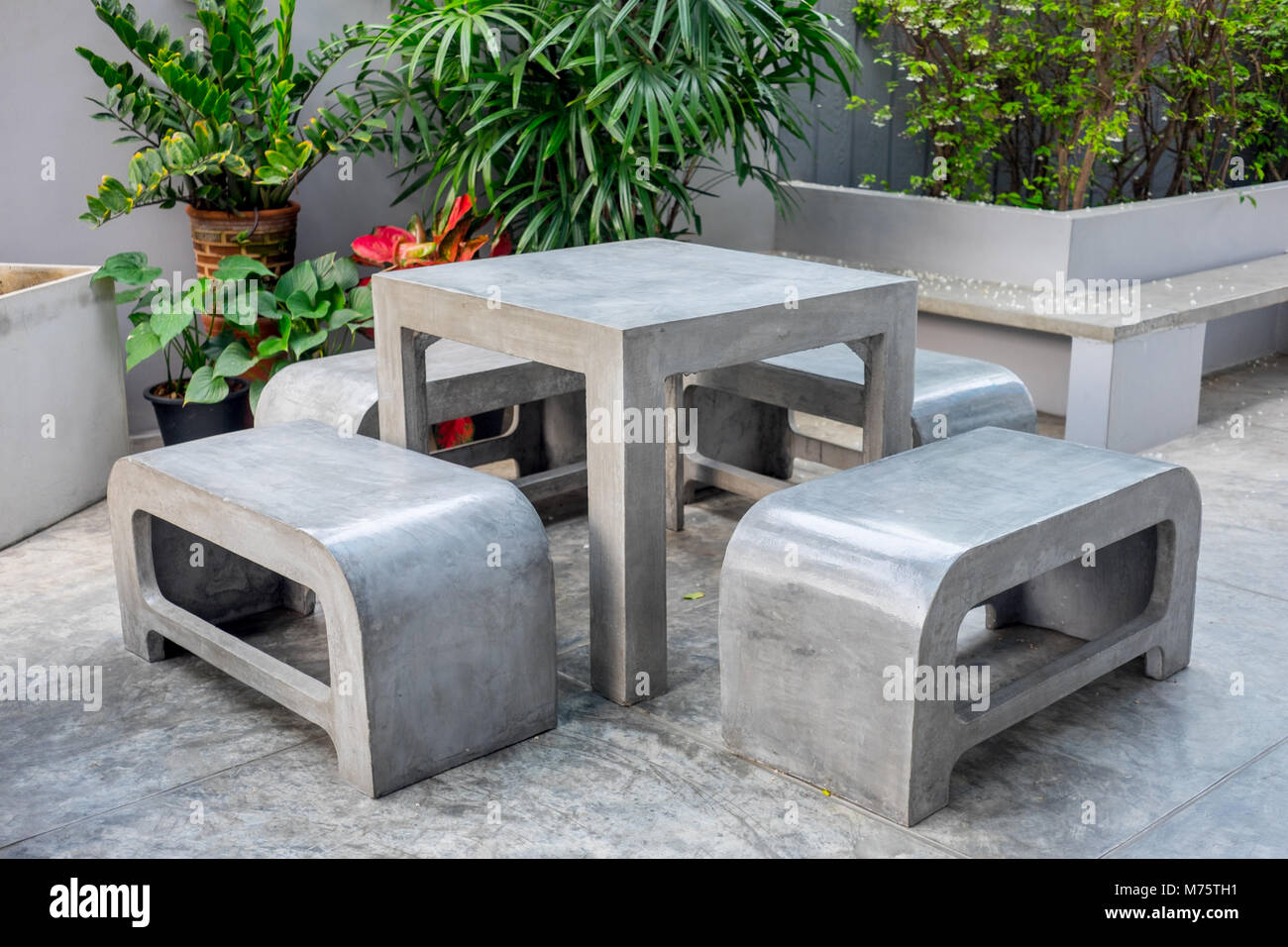 Concrete Outdoor Furniture Set In The Small Garden Including On Table And Four Benches Stock Photo Alamy