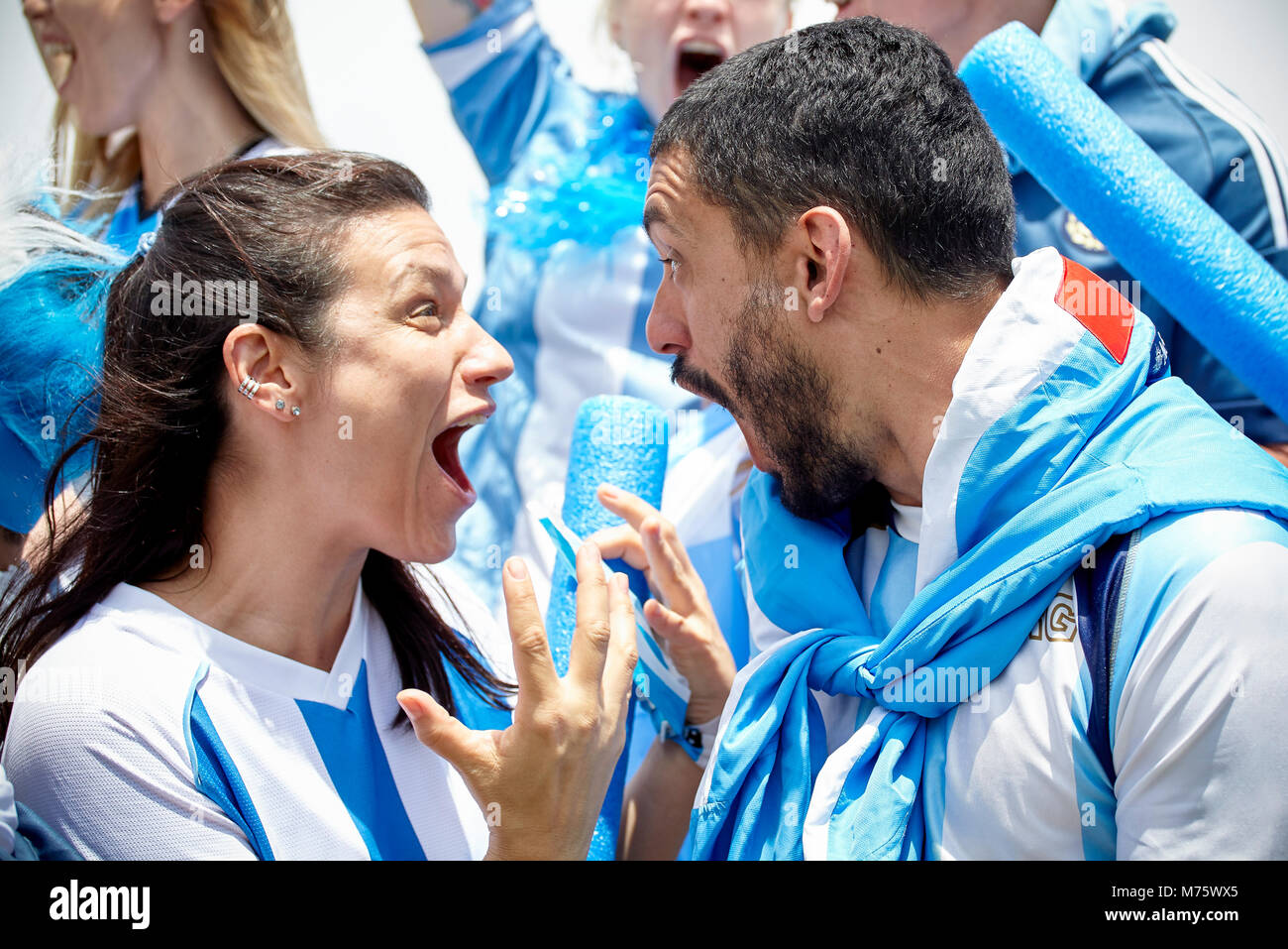 Argentinian football fans shouting excitedly at match Stock Photo