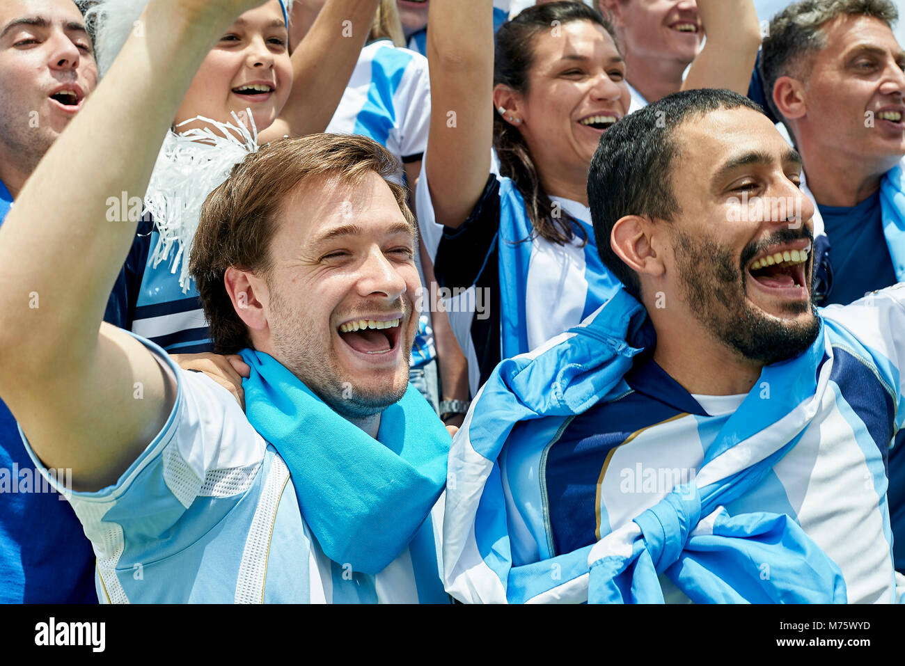 Argentinian football fans watching football match Stock Photo