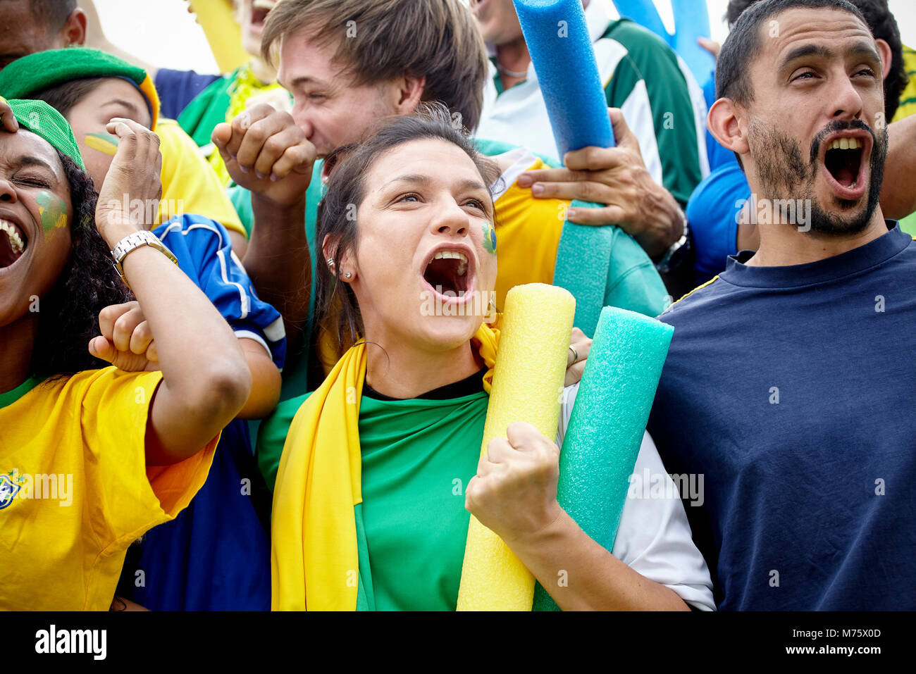 Brazilian football fans celebrating victory at football match Stock Photo