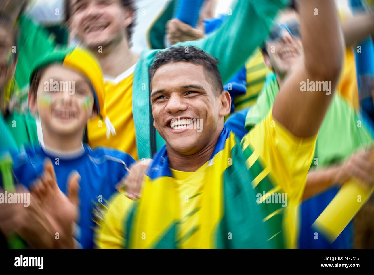 Brazilian football fans cheering at football match Stock Photo