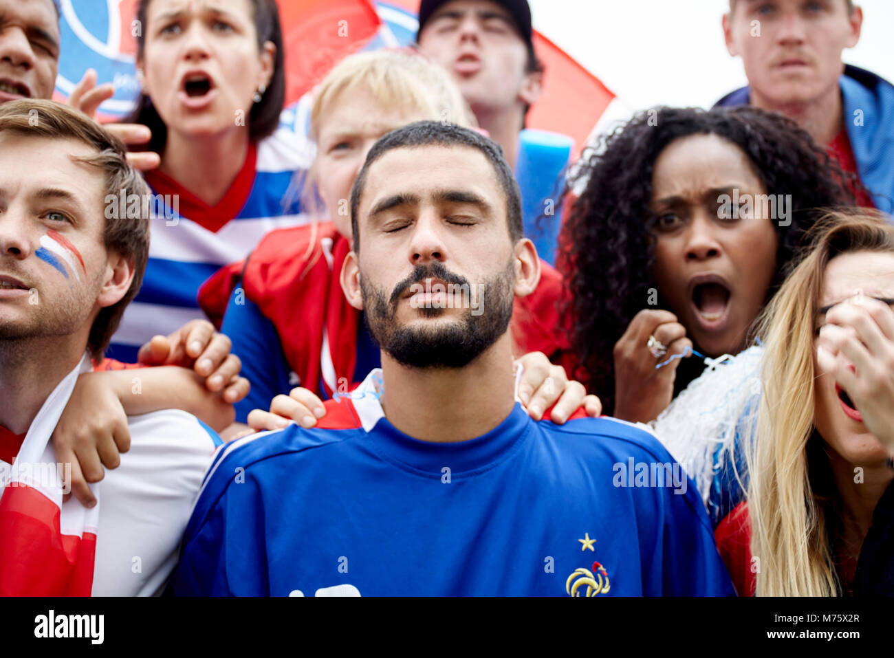 French football fans looking shocked and disappointed at match Stock Photo