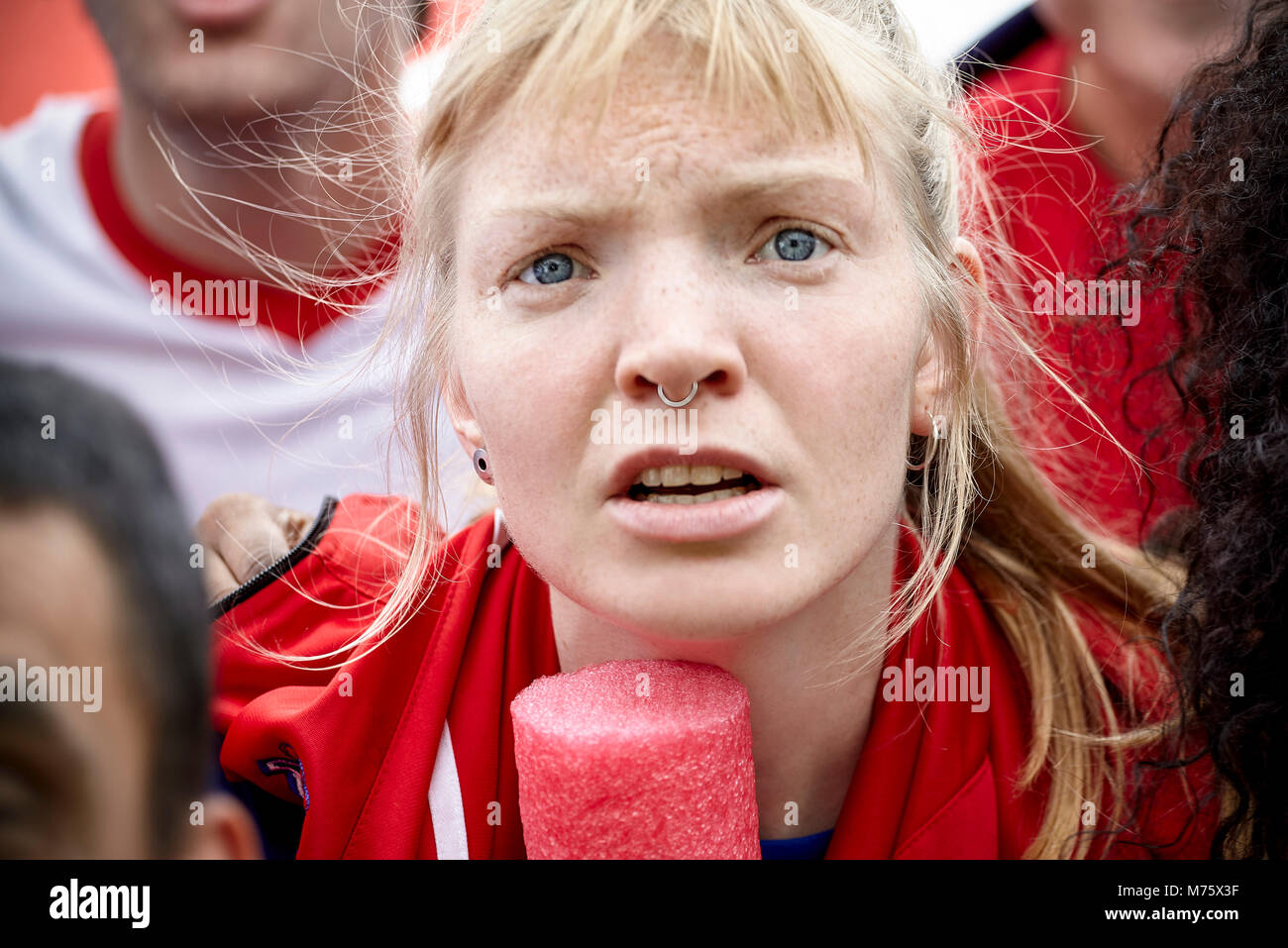 Woman watching football match with furrowed brow, portrait Stock Photo