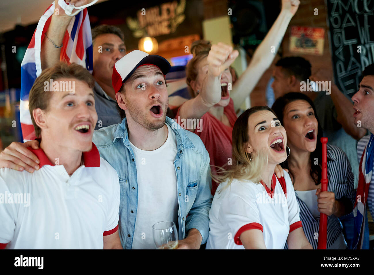 English soccer fans watching math together at pub Stock Photo