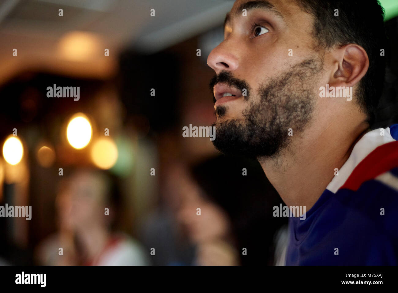 Man watching sports match in bar Stock Photo