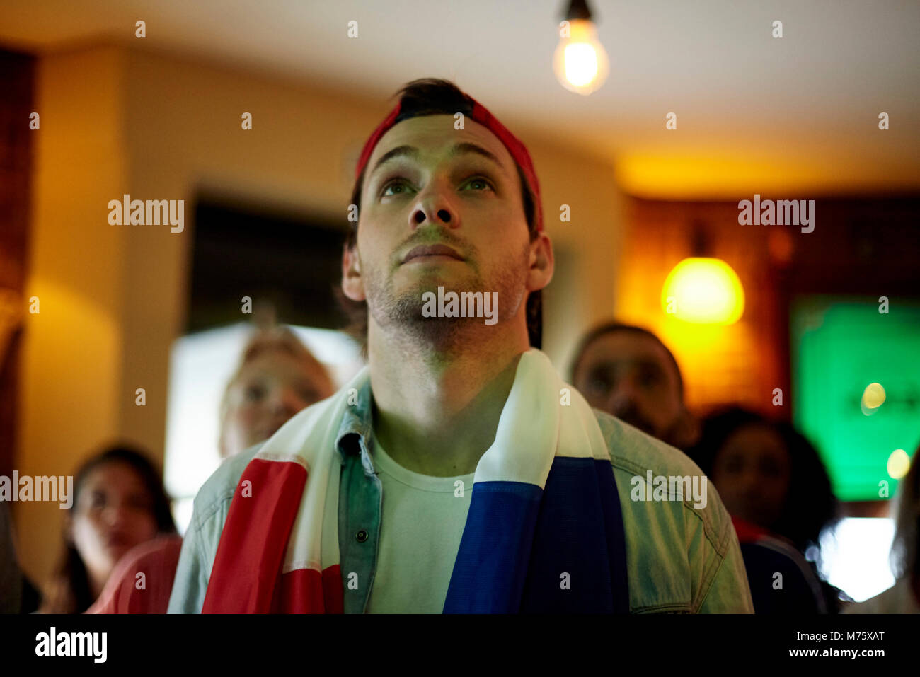 French football fan watching match in bar Stock Photo