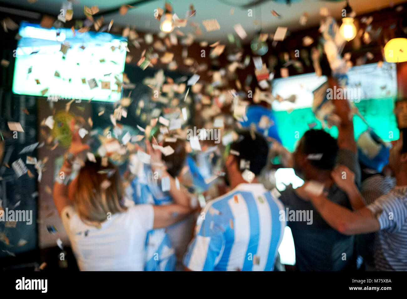 Argentinian football fans watching football match at sports bar Stock Photo