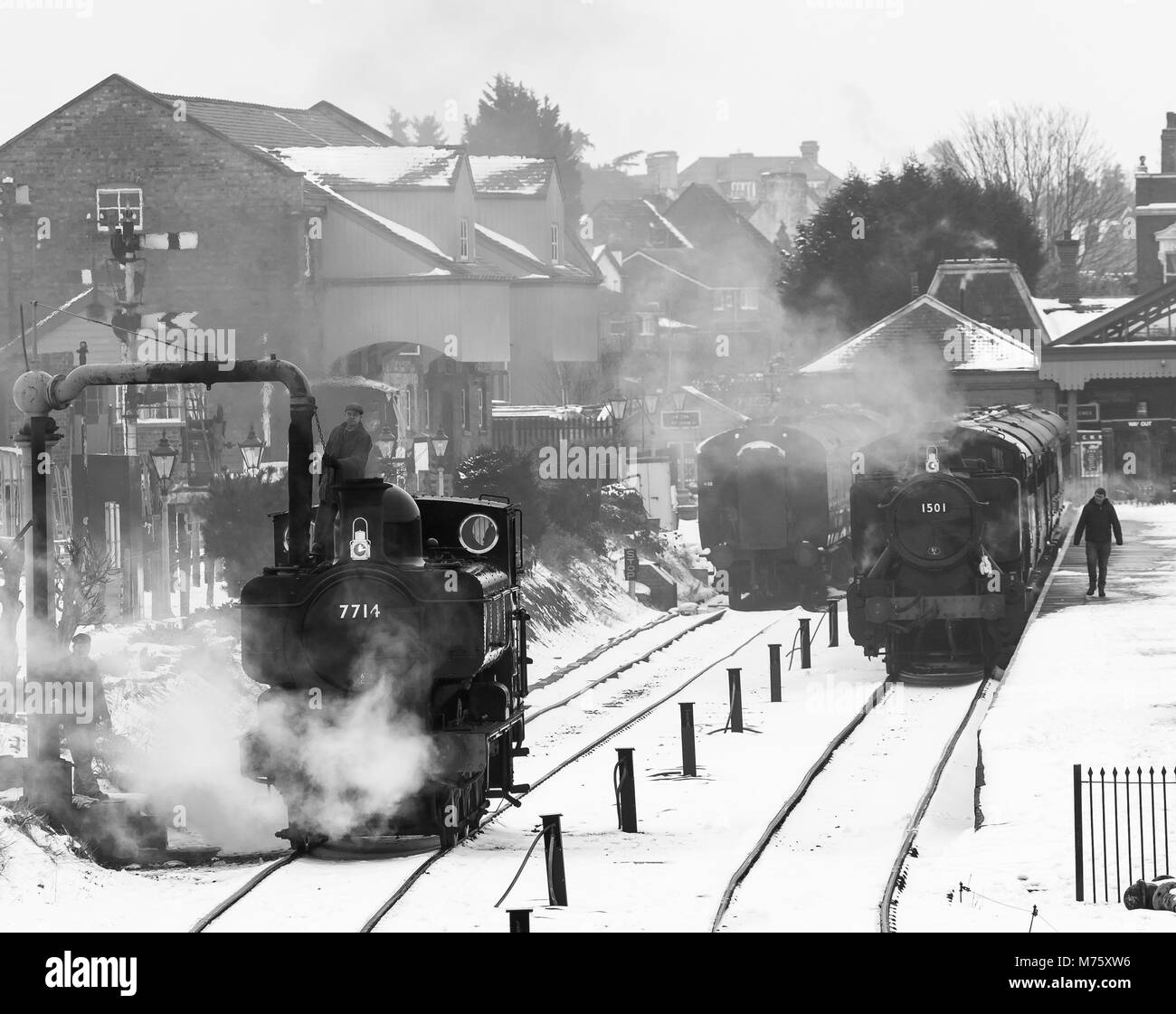 Black & white view of morning preparations, Severn Valley Railway, Kidderminster in the snow. Full steam ahead for trains despite winter snow on track. Stock Photo