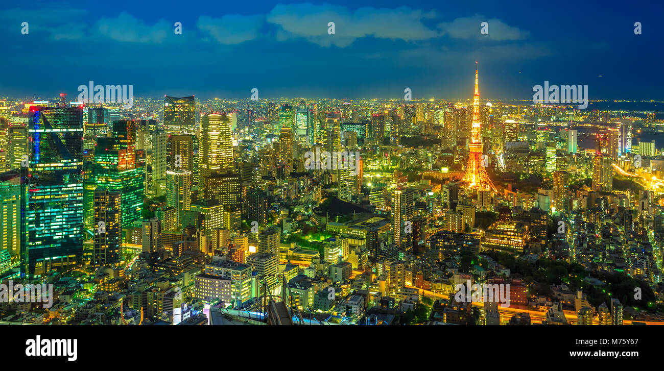 Panorama of Tokyo Skyline at blue hour with illuminated Tokyo Tower from observatory in Roppongi Hills complex, Minato District, Tokyo, Japan. Aerial view Stock Photo