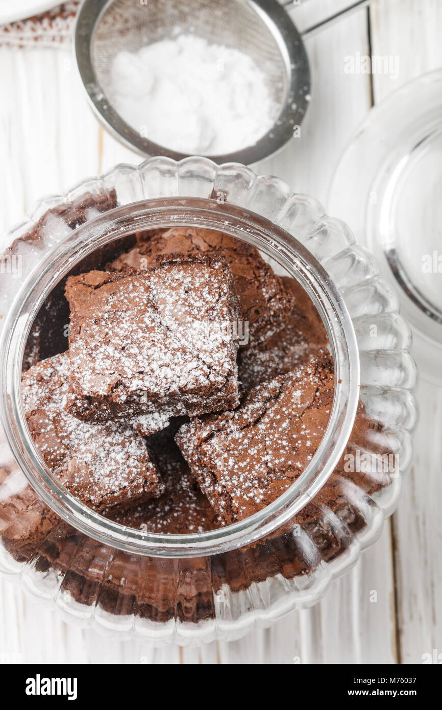Squares brownies in a jar. Chocolate dessert. Traditional dish of