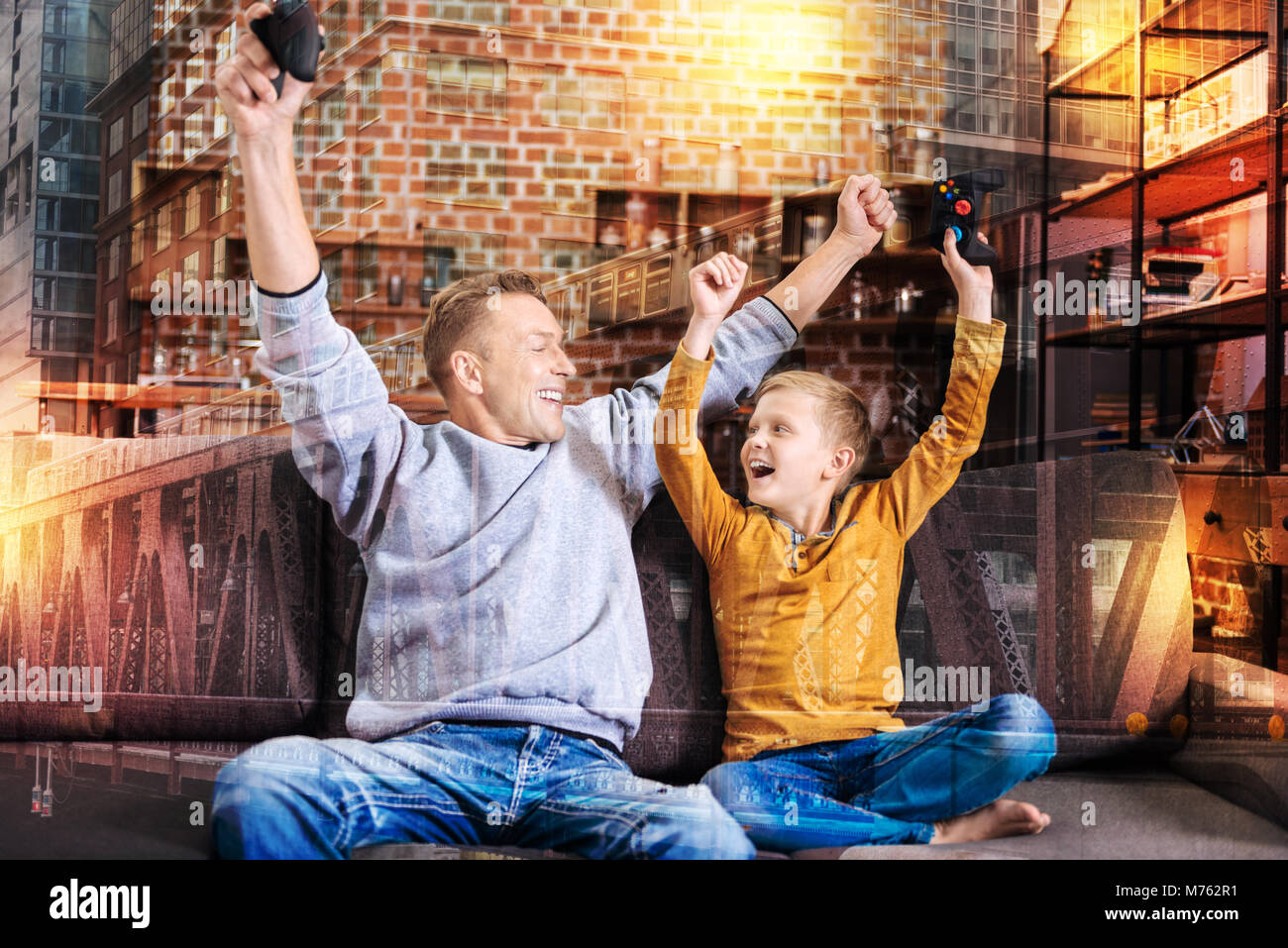 Excited relatives celebrating their victory in a video game Stock Photo