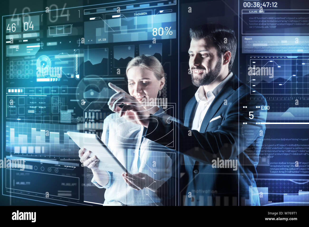 Cheerful friendly programmers smiling while working together Stock Photo