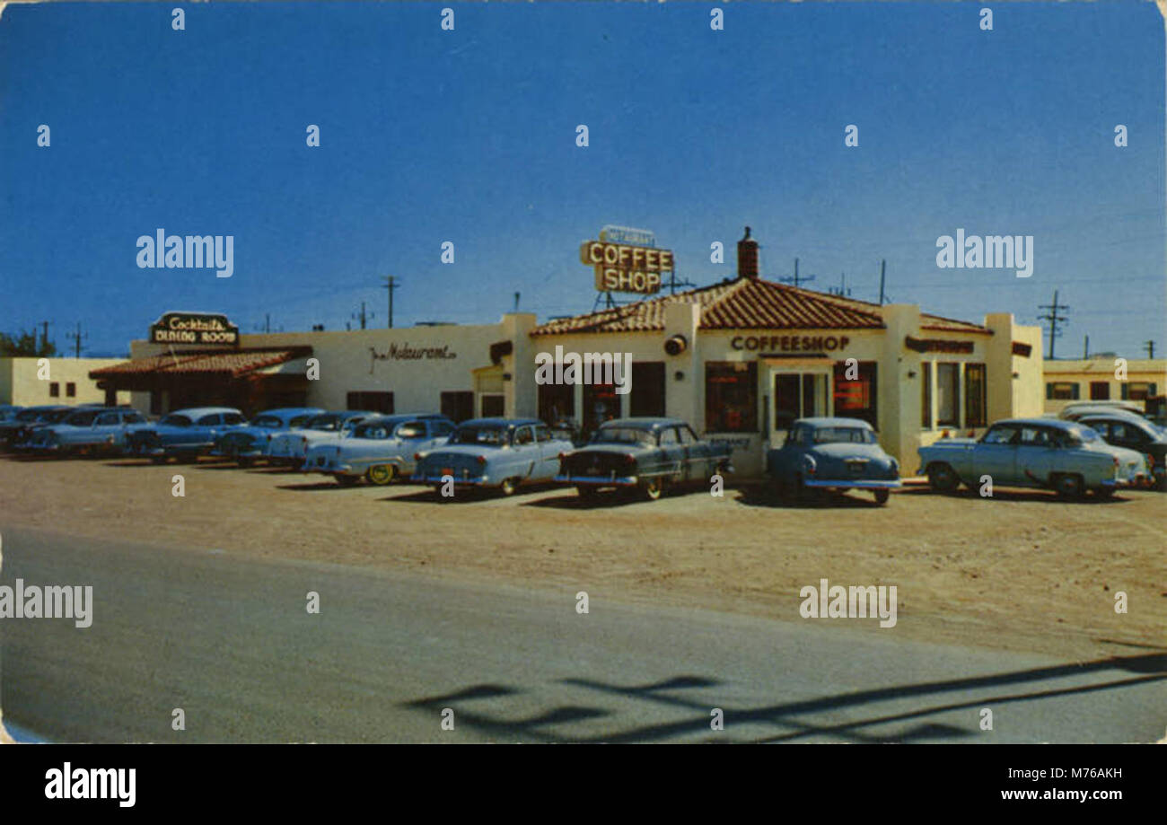 A photograph of a 'Motaurant,' a 1950s roadside restaurant designed for car service. The image captures the mid-century modern architectural style and cultural shift towards automobile-centric dining experiences in post-war America. Stock Photo